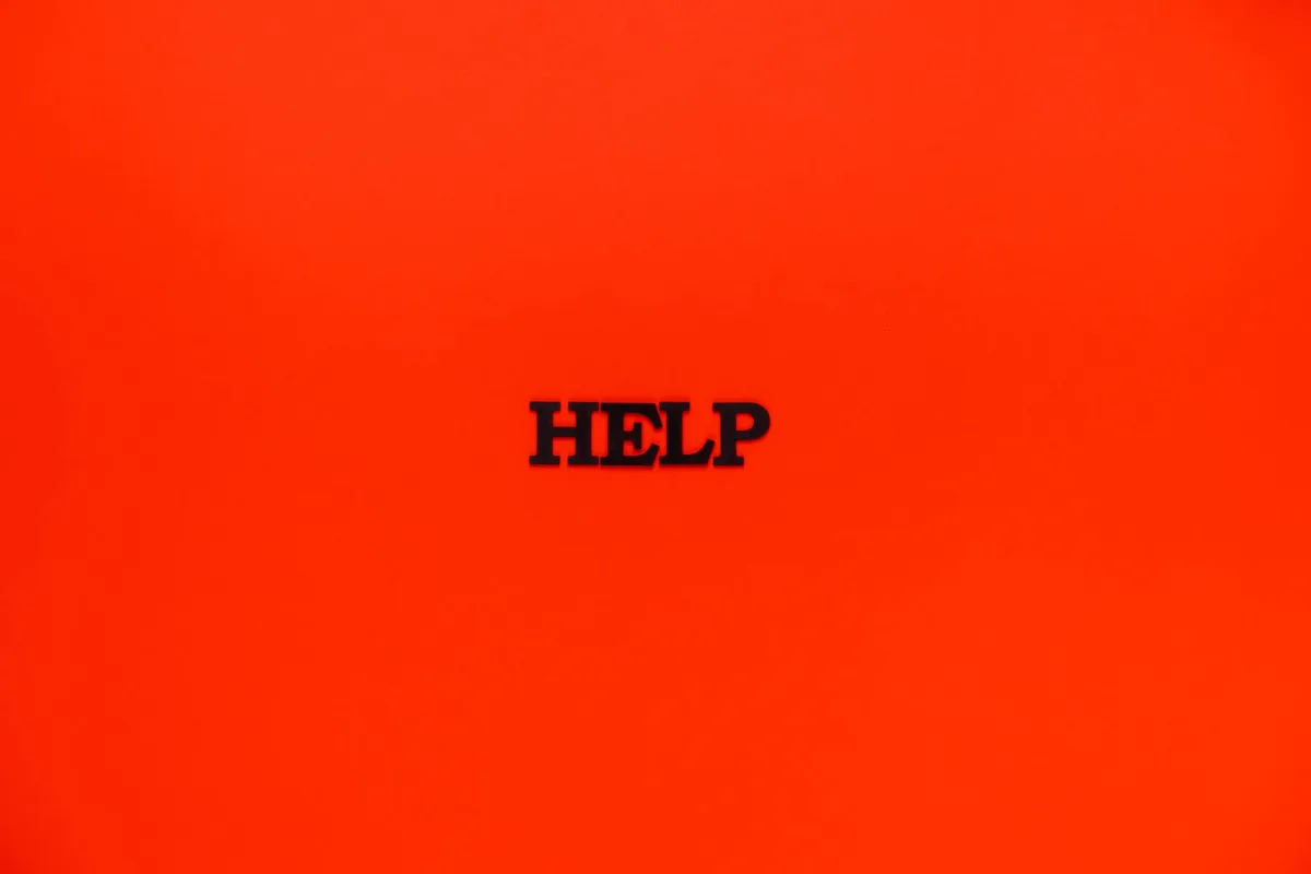 Minimalist red background featuring the word 'HELP' in bold text. Minimalist red background featuring the word 'HELP' in bold text.