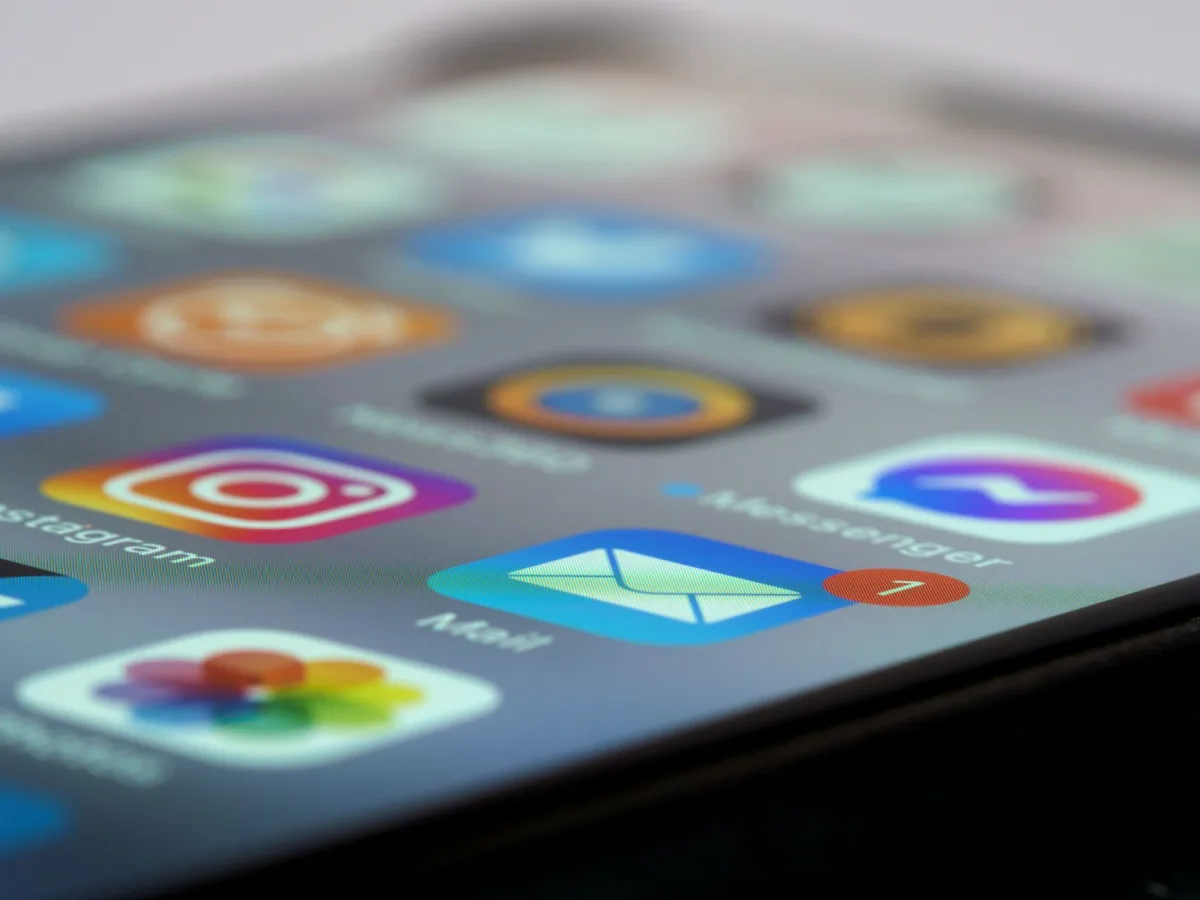 Detailed close-up of smartphone screen displaying various app icons and notifications. Detailed close-up of smartphone screen displaying various app icons and notifications.