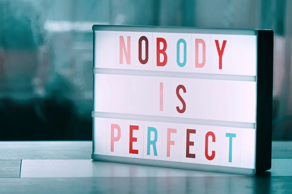 Close-up of a light box displaying 'Nobody is Perfect' inspiring self-acceptance. Close-up of a light box displaying 'Nobody is Perfect' inspiring self-acceptance.