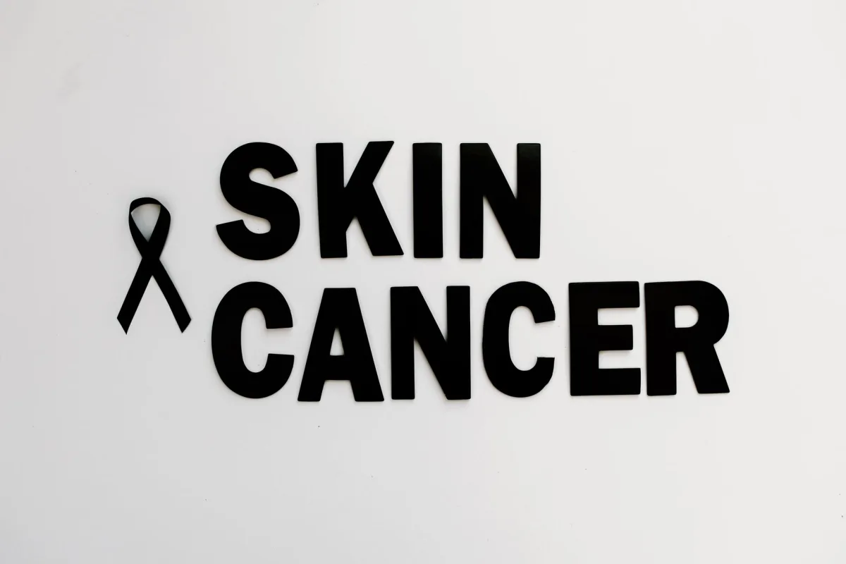 Conceptual image of skin cancer awareness with black ribbon on white background. Conceptual image of skin cancer awareness with black ribbon on white background.