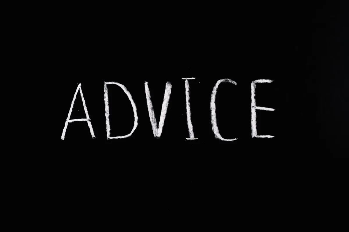 Inspirational word 'Advice' written in white chalk on blackboard.