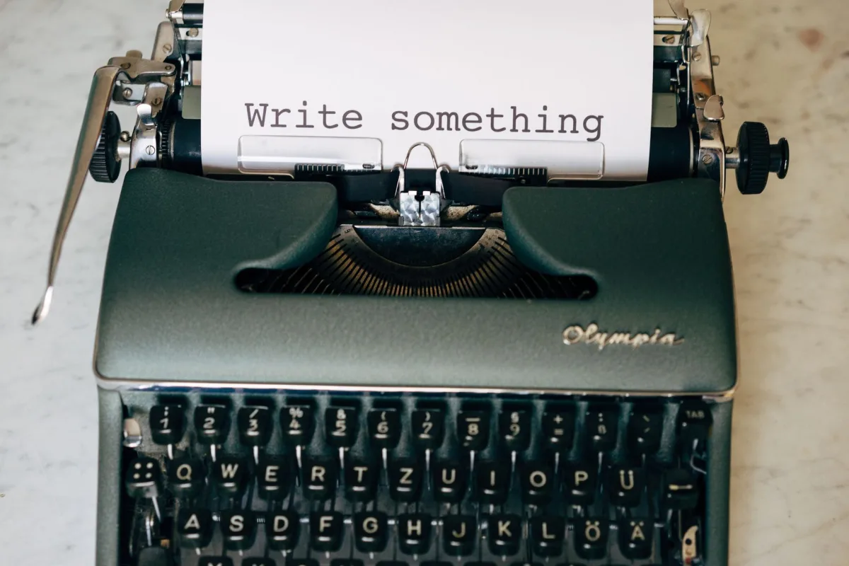 Classic typewriter displaying 'Write something' on paper. Perfect creative inspiration. Classic typewriter displaying 'Write something' on paper. Perfect creative inspiration.