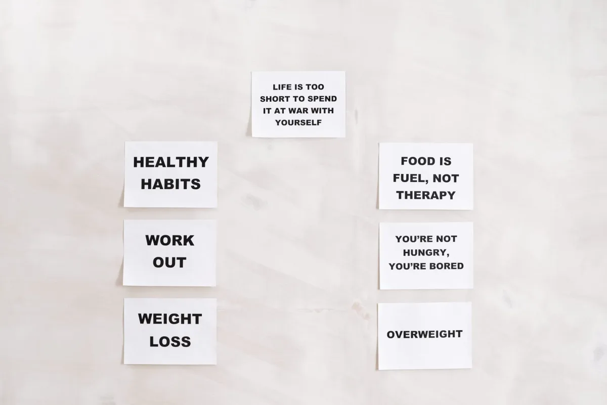 Minimalist display of health and wellness quotes emphasizing healthy habits and weight management.