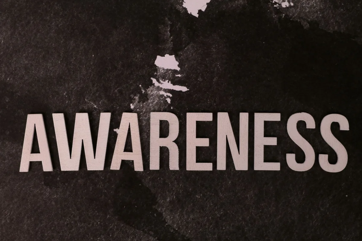 Text 'Awareness' on a dark textured backdrop promotes mindfulness and social causes. Text 'Awareness' on a dark textured backdrop promotes mindfulness and social causes.