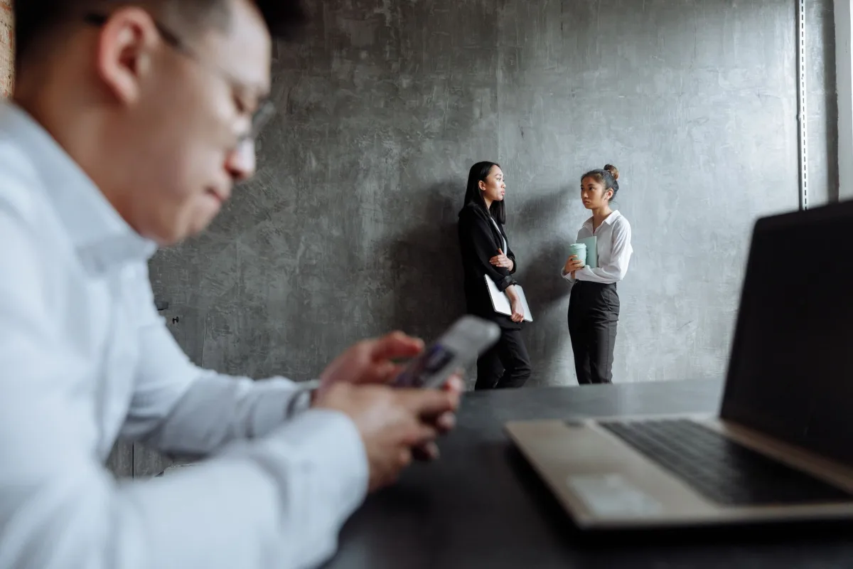Business professionals engaged in a conversation in a contemporary office setting. Business professionals engaged in a conversation in a contemporary office setting.