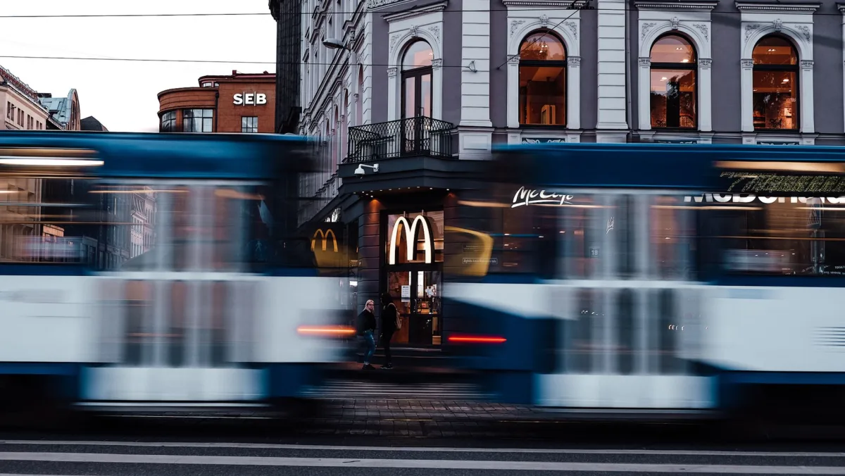 Dynamic urban street scene with trams and McDonald's in Riga.