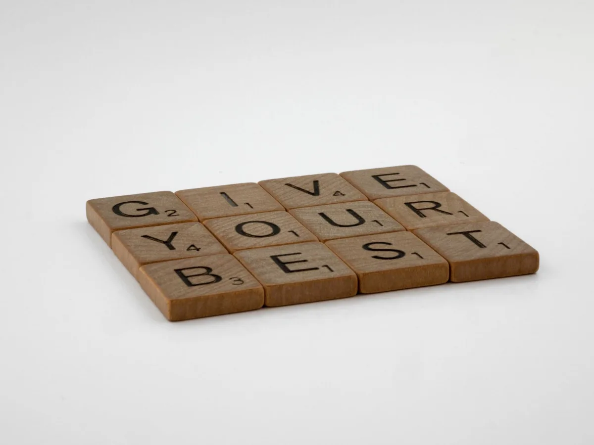 Wooden scrabble tiles arranged to spell 'Give Your Best' on a simple background. Wooden scrabble tiles arranged to spell 'Give Your Best' on a simple background.