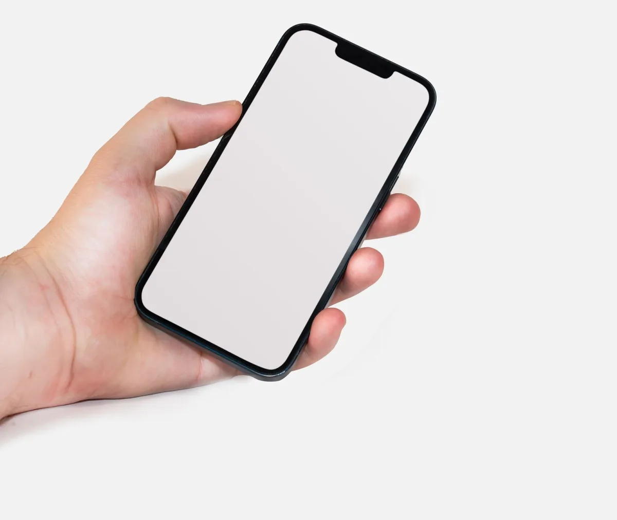 A hand holding a smartphone with a blank screen, perfect for mockups and design templates. A hand holding a smartphone with a blank screen, perfect for mockups and design templates.