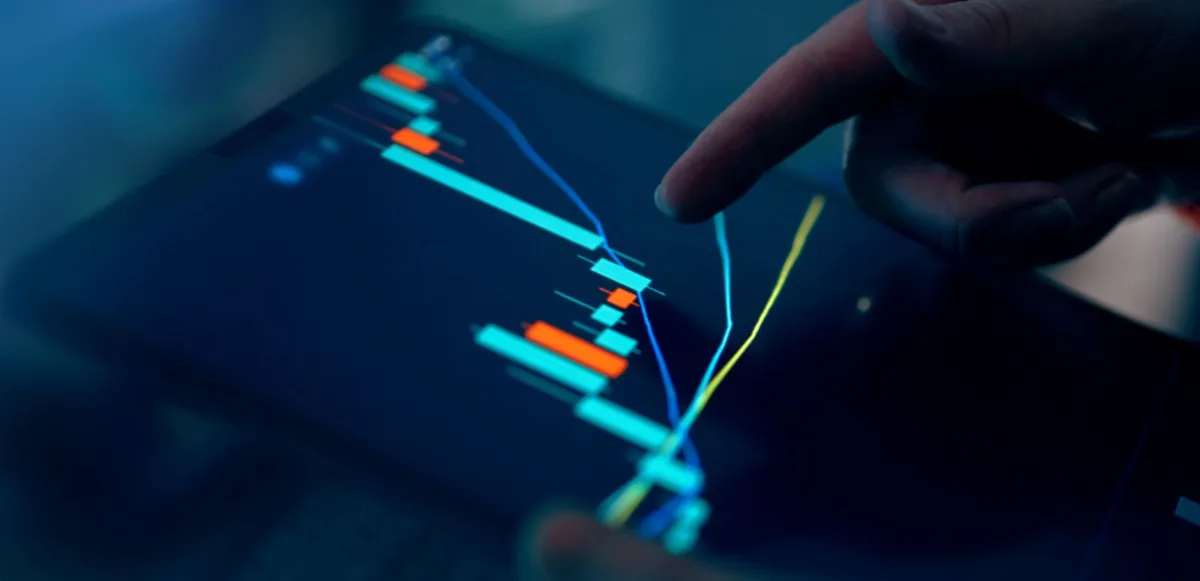 Close-up of a finger interacting with a digital chart on a tablet, depicting financial data and analysis. Close-up of a finger interacting with a digital chart on a tablet, depicting financial data and analysis.