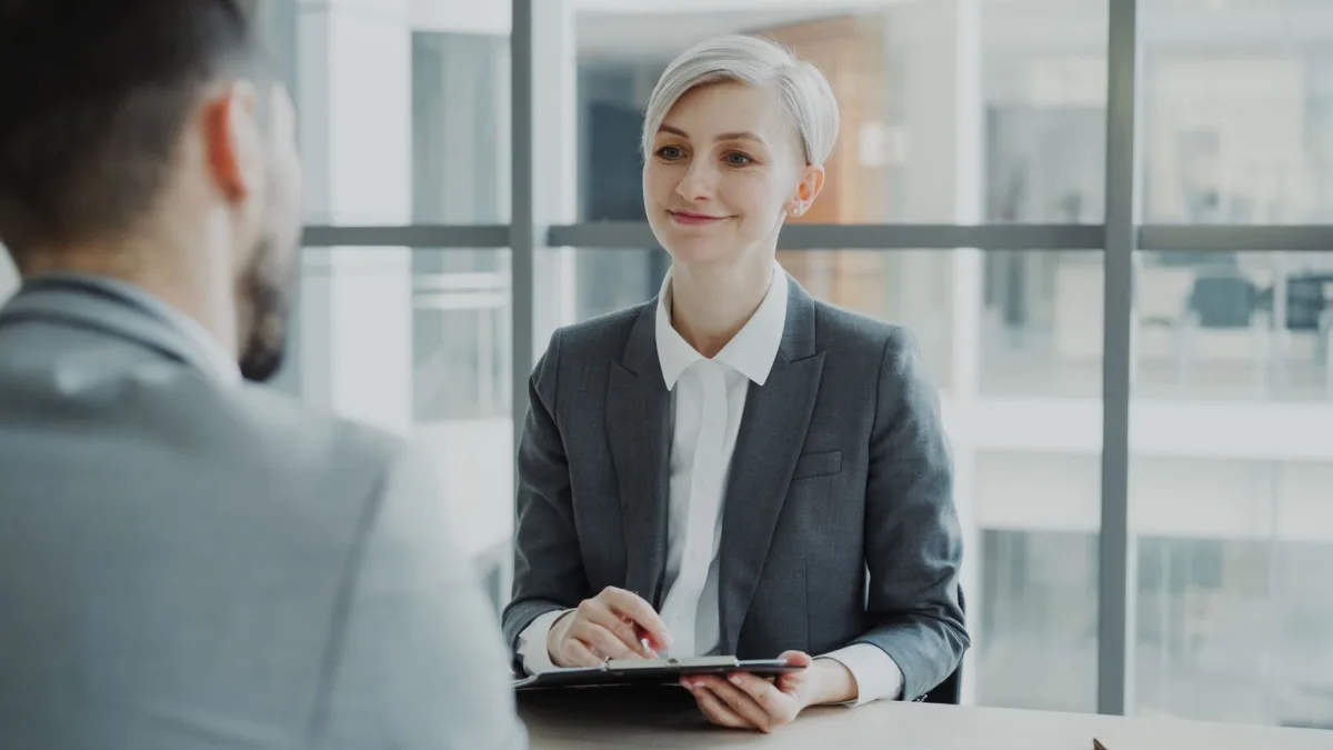 Confident woman interviewing candidate in a modern office. Ideal business and visuals. Confident woman interviewing candidate in a modern office. Ideal business and visuals.