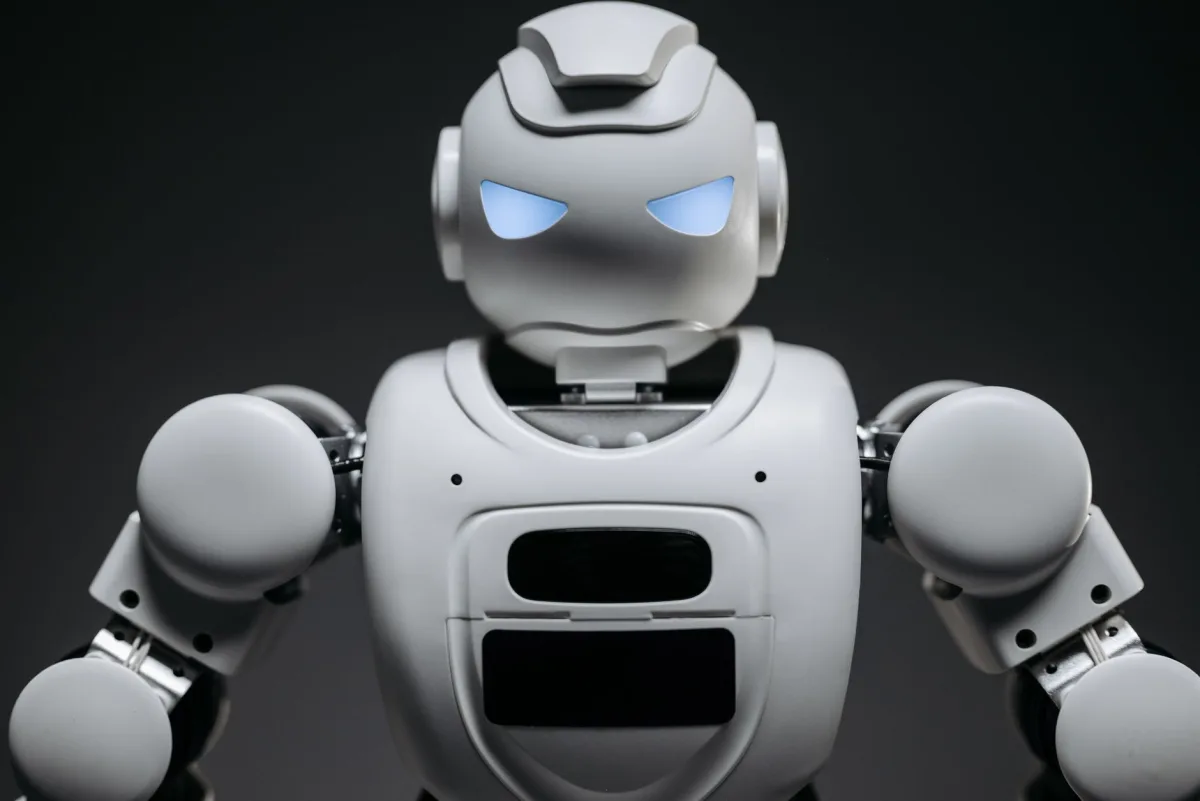Detailed studio shot of a modern robotic toy with a dark background, showcasing technological design. Detailed studio shot of a modern robotic toy with a dark background, showcasing technological design.