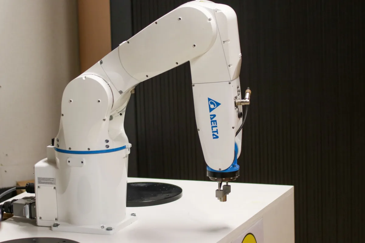 Close-up of a Delta brand robotic arm in an industrial setting, showcasing automation technology. Close-up of a Delta brand robotic arm in an industrial setting, showcasing automation technology.