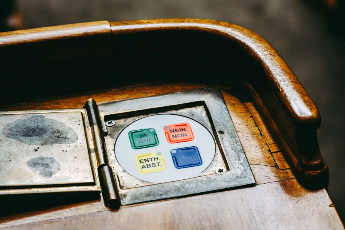 Wooden voting panel with buttons in Bern's Parliament, Switzerland.