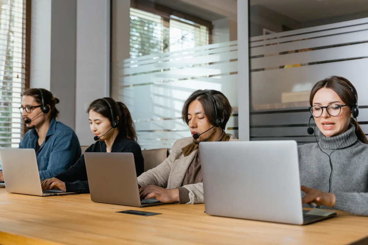 Four agents working diligently in an office setting. Four agents working diligently in an office setting.
