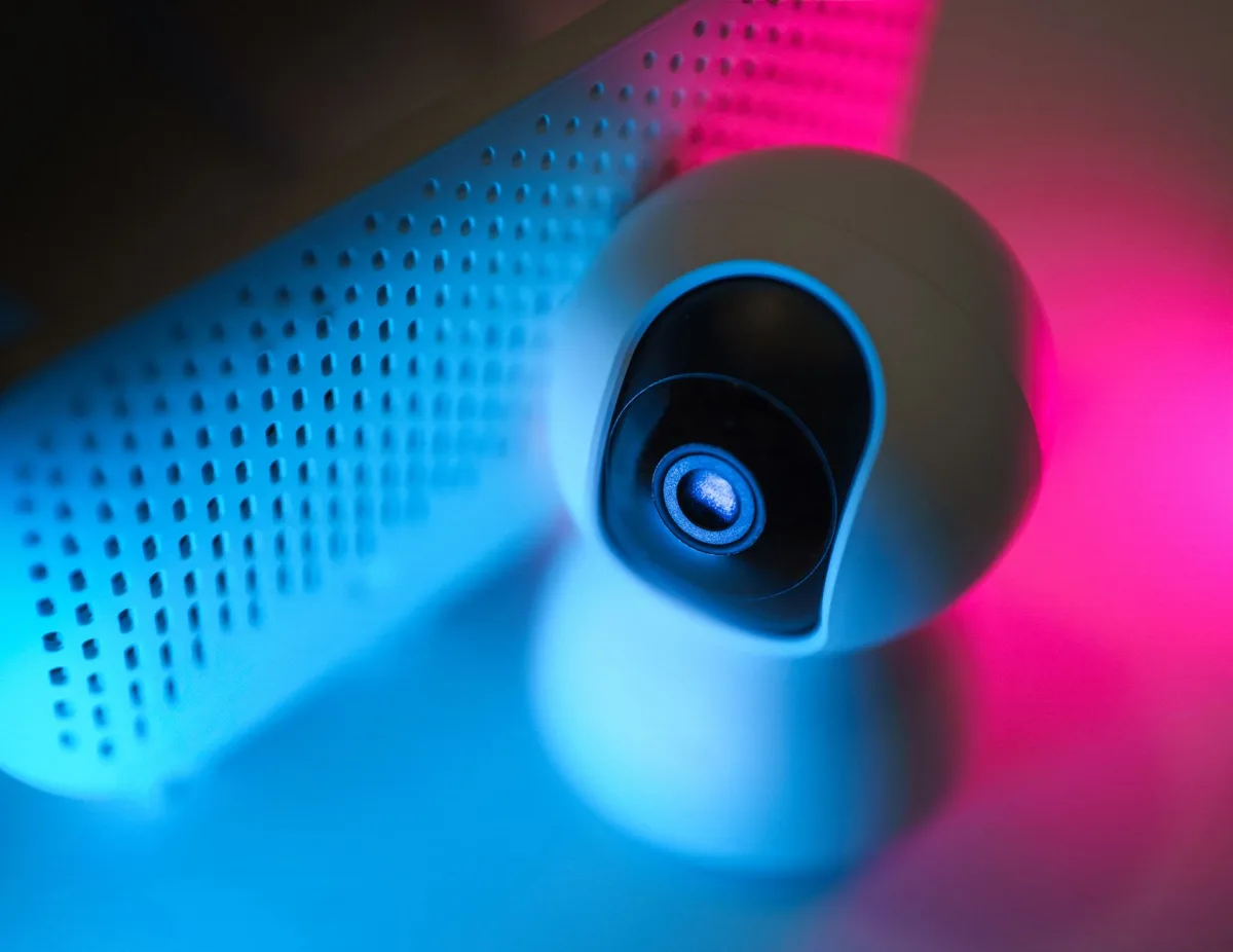 Close-up of a surveillance camera with neon lighting, symbolizing modern home security technology. Close-up of a surveillance camera with neon lighting, symbolizing modern home security technology.