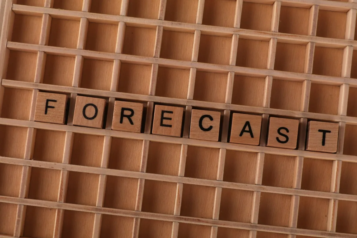 Scrabble-like wooden blocks spelling word 'forecast' on a wooden grid surface. Scrabble-like wooden blocks spelling word 'forecast' on a wooden grid surface.