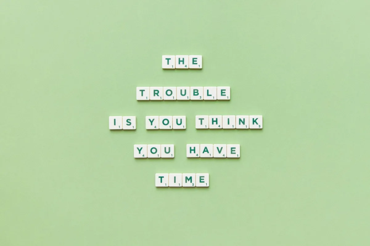 Scrabble tiles arranged to spell a motivational quote against a green background. Scrabble tiles arranged to spell a motivational quote against a green background.