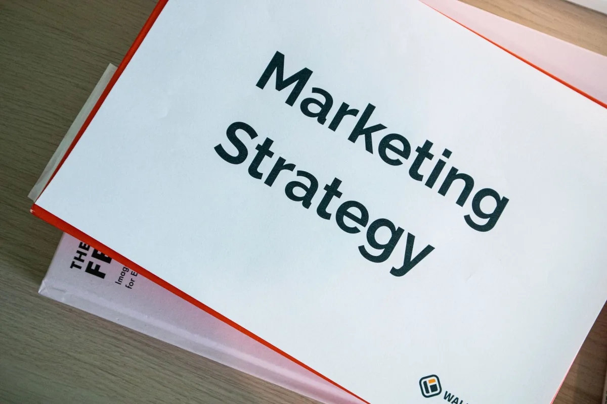 A marketing strategy document displayed on a desk, showcasing business planning essentials. A marketing strategy document displayed on a desk, showcasing business planning essentials.