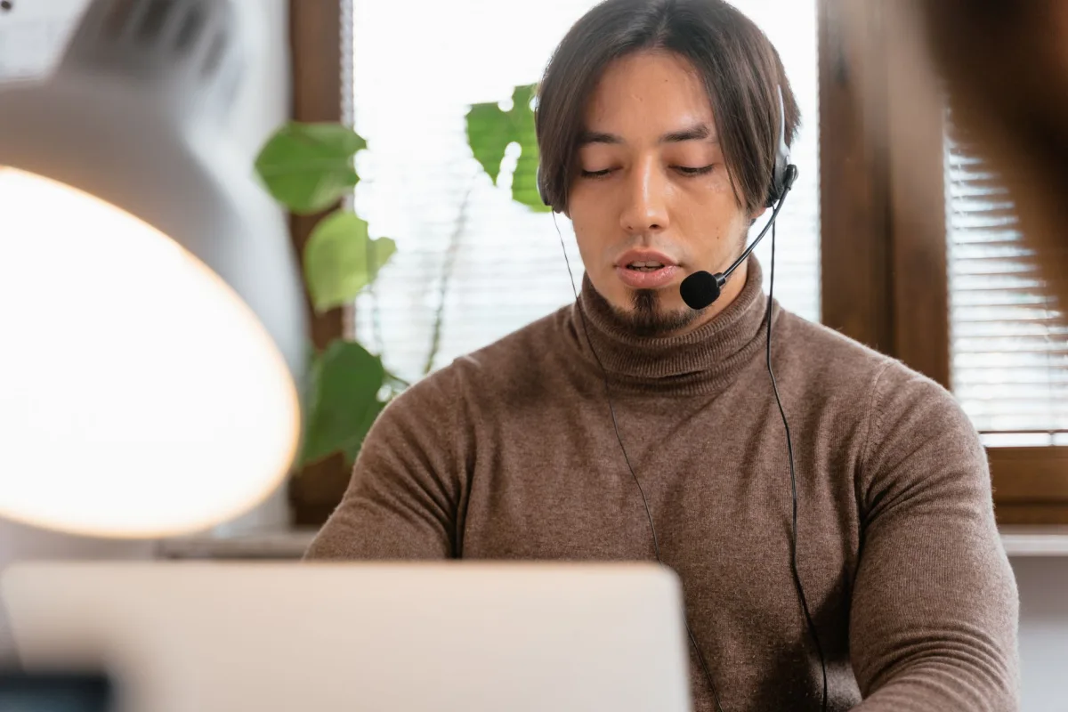Call center operator with a headset working from home office, focused on Call center operator with a headset working from home office, focused on