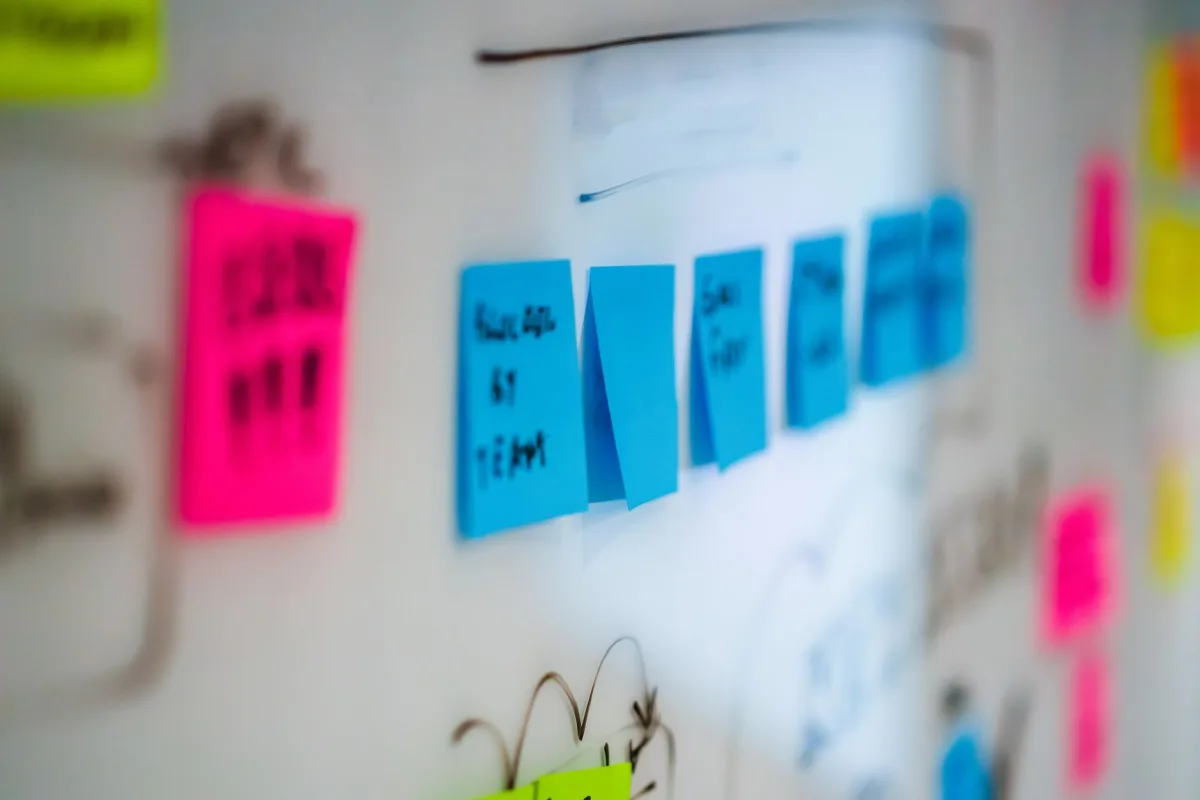 Sticky notes on a whiteboard during a creative brainstorming session an office.