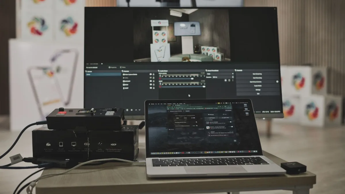 Multimedia setup featuring a laptop and a large monitor in a tech-savvy workspace. Multimedia setup featuring a laptop and a large monitor in a tech-savvy workspace.