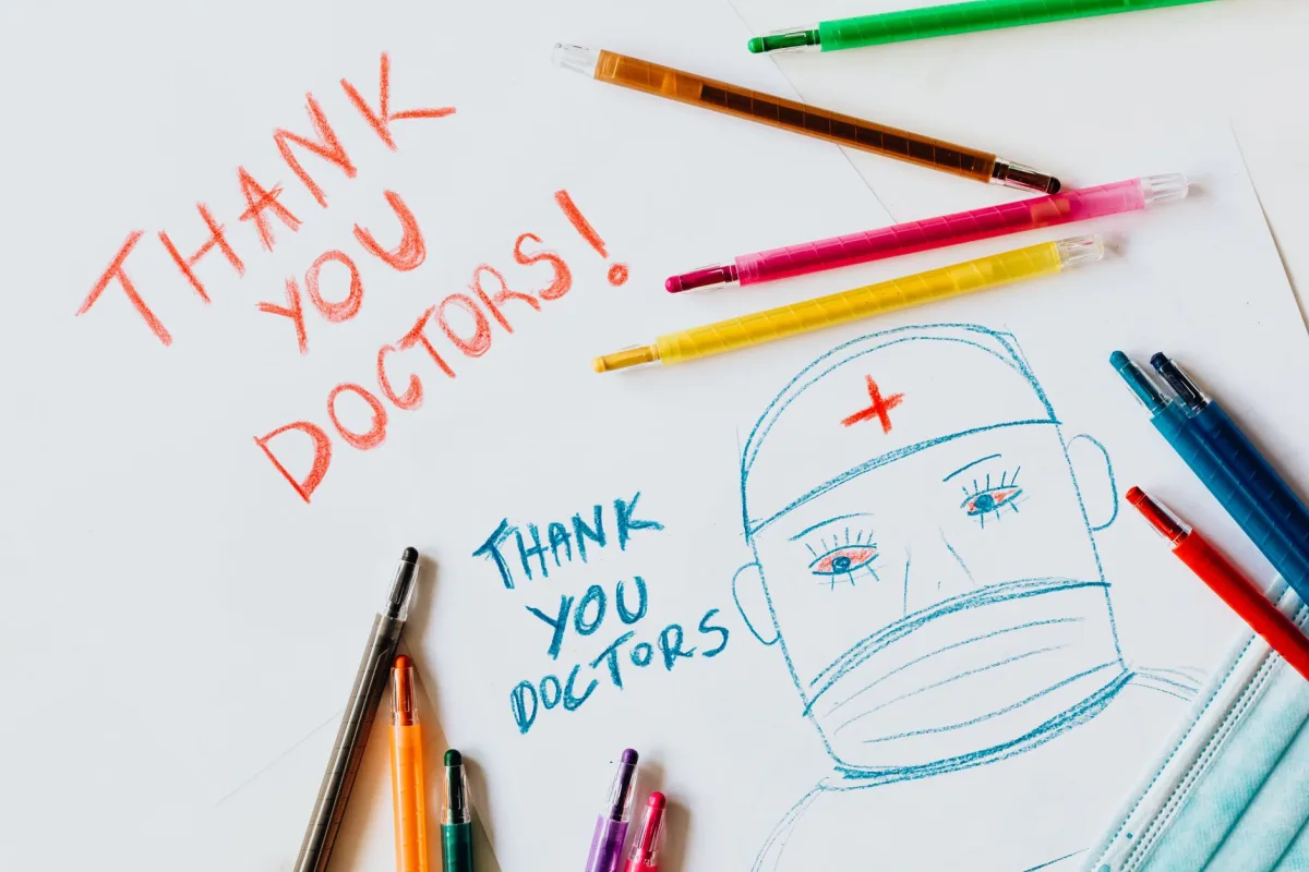 Handwritten notes and drawing of a doctor with color pencils.