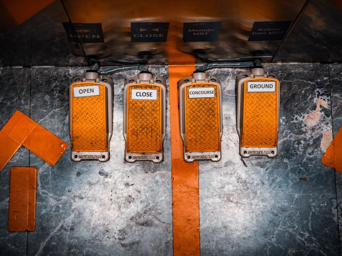 Top view of orange industrial pedals labeled for MRT control in Jakarta, Indonesia.